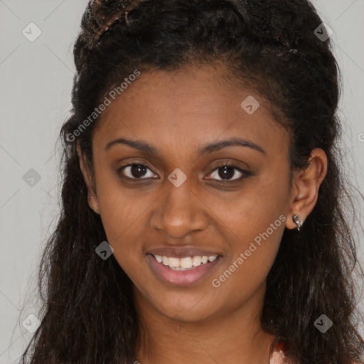 Joyful black young-adult female with long  brown hair and brown eyes