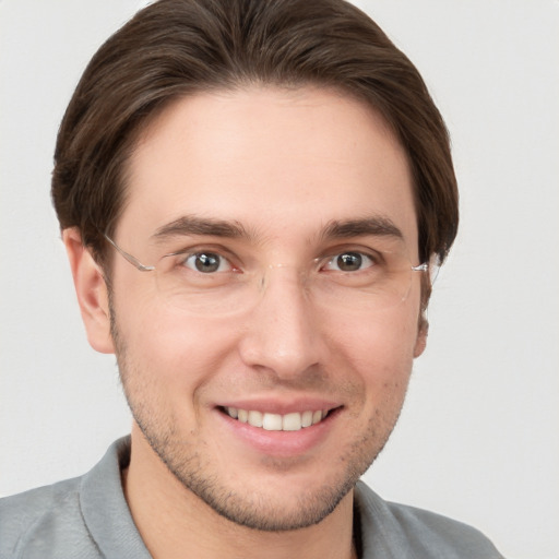 Joyful white young-adult male with short  brown hair and grey eyes