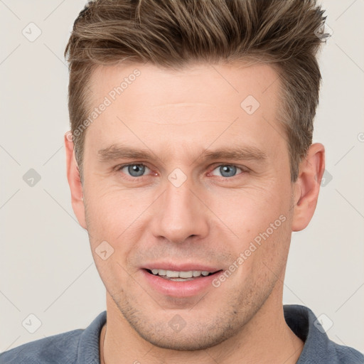 Joyful white adult male with short  brown hair and grey eyes