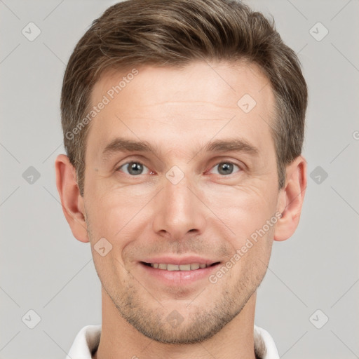 Joyful white young-adult male with short  brown hair and grey eyes