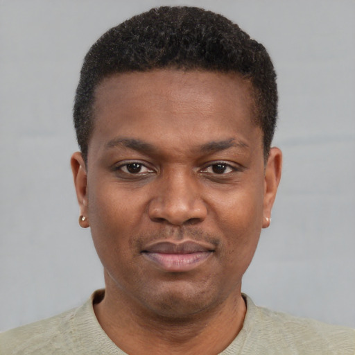 Joyful black young-adult male with short  brown hair and brown eyes