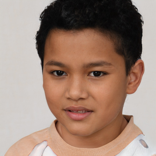 Joyful latino child male with short  brown hair and brown eyes