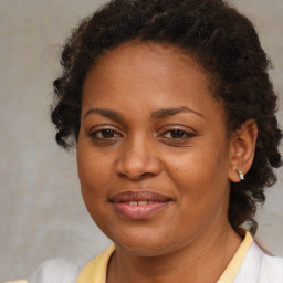 Joyful black adult female with medium  brown hair and brown eyes