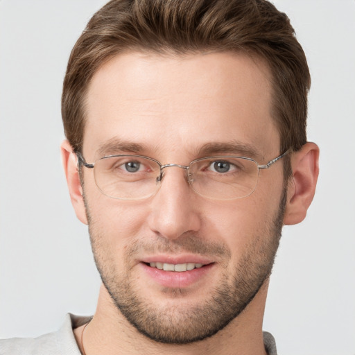 Joyful white young-adult male with short  brown hair and grey eyes