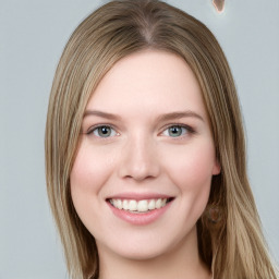 Joyful white young-adult female with long  brown hair and blue eyes