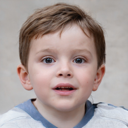 Joyful white child male with short  brown hair and blue eyes