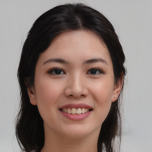 Joyful asian young-adult female with long  black hair and brown eyes