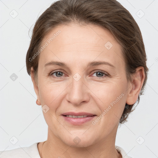 Joyful white adult female with short  brown hair and grey eyes