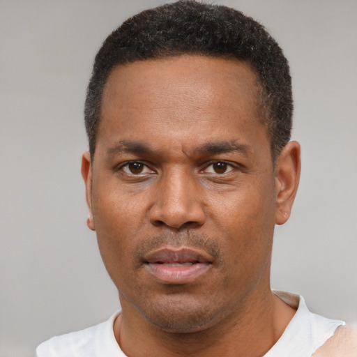 Neutral latino adult male with short  brown hair and brown eyes
