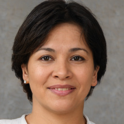 Joyful white adult female with medium  brown hair and brown eyes