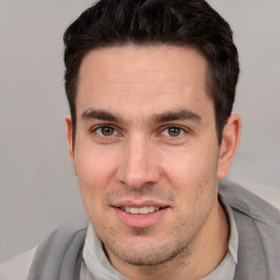 Joyful white adult male with short  brown hair and brown eyes