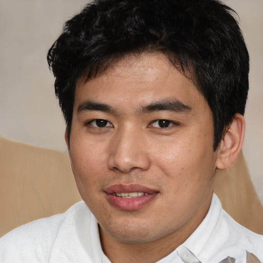 Joyful asian young-adult male with short  brown hair and brown eyes