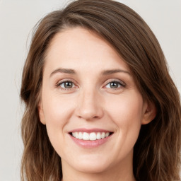 Joyful white young-adult female with long  brown hair and green eyes