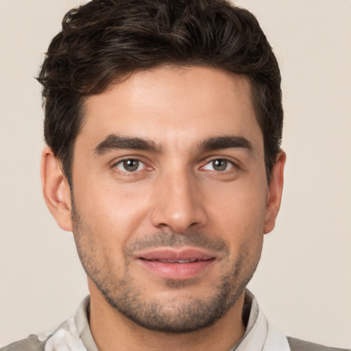 Joyful white young-adult male with short  brown hair and brown eyes