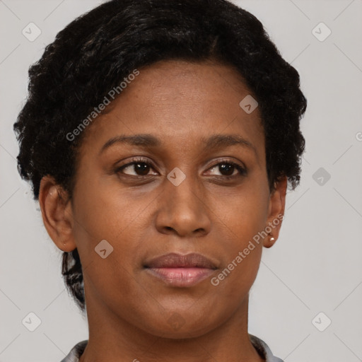 Joyful black adult female with short  brown hair and brown eyes