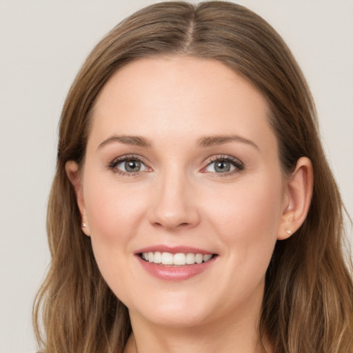 Joyful white young-adult female with long  brown hair and grey eyes