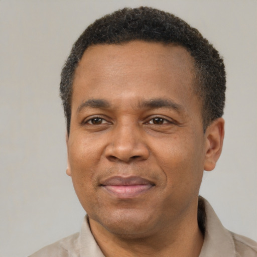 Joyful latino adult male with short  black hair and brown eyes
