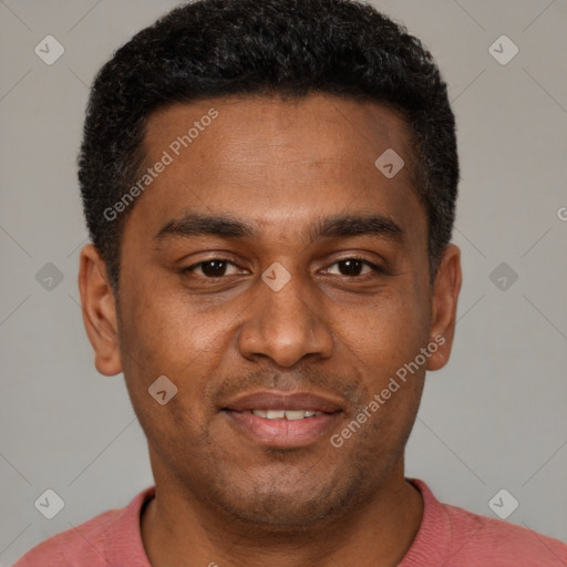 Joyful black young-adult male with short  brown hair and brown eyes