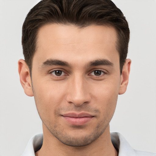 Joyful white young-adult male with short  brown hair and brown eyes