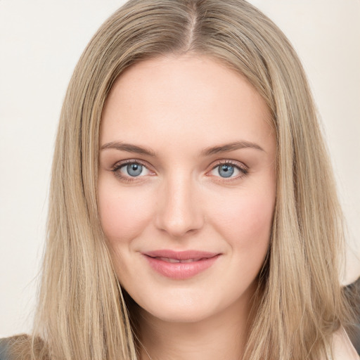 Joyful white young-adult female with long  brown hair and green eyes