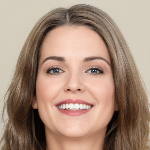 Joyful white young-adult female with long  brown hair and brown eyes