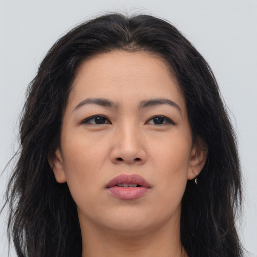 Joyful asian young-adult female with long  brown hair and brown eyes