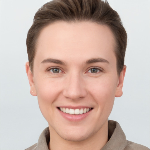 Joyful white young-adult female with short  brown hair and grey eyes