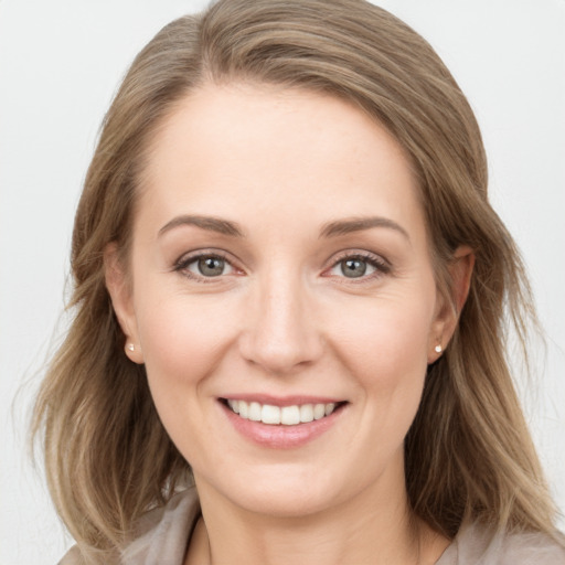 Joyful white young-adult female with long  brown hair and grey eyes