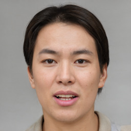 Joyful asian young-adult male with short  brown hair and brown eyes