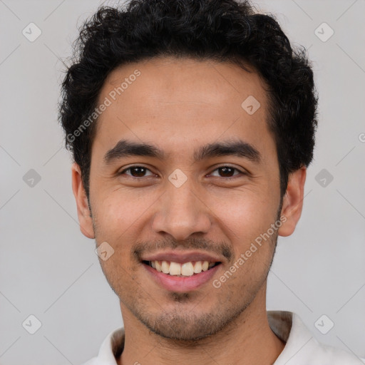 Joyful white young-adult male with short  black hair and brown eyes