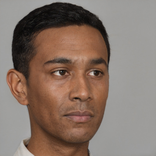 Neutral black young-adult male with short  black hair and brown eyes