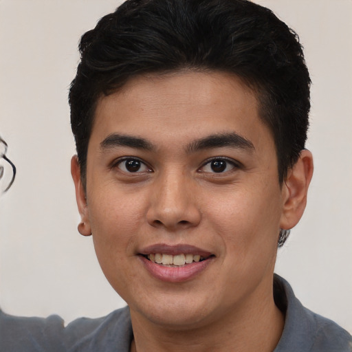 Joyful asian young-adult male with short  brown hair and brown eyes