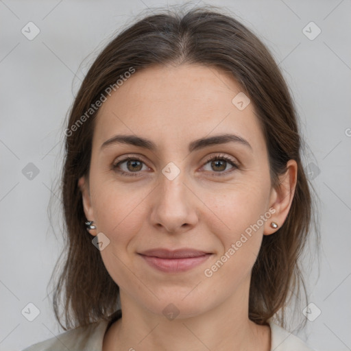 Joyful white young-adult female with medium  brown hair and grey eyes