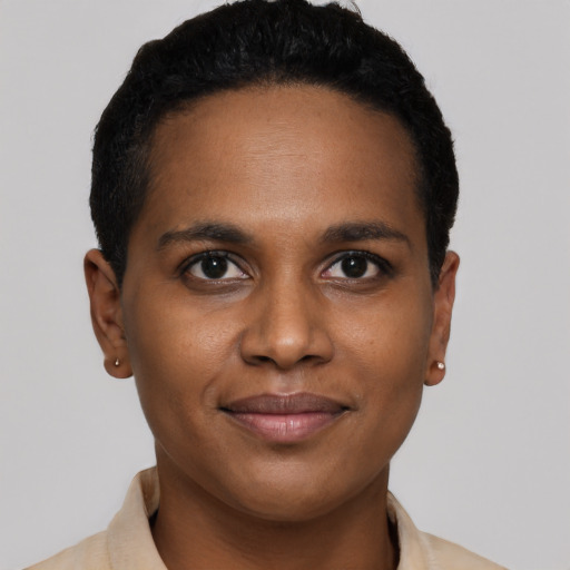 Joyful black young-adult female with short  brown hair and brown eyes
