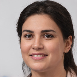 Joyful white young-adult female with medium  brown hair and brown eyes