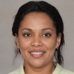 Joyful black adult female with medium  brown hair and brown eyes