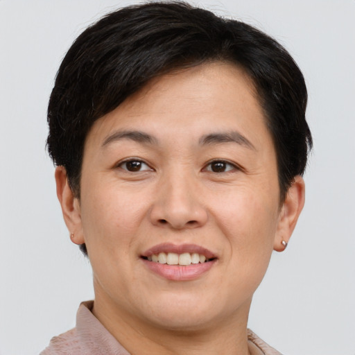 Joyful white young-adult female with short  brown hair and brown eyes