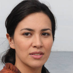 Joyful asian young-adult female with medium  brown hair and brown eyes