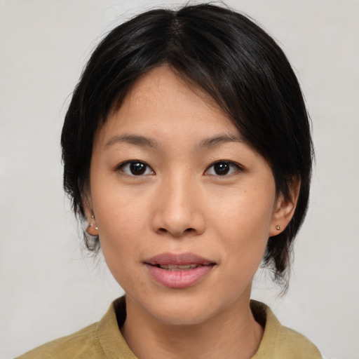 Joyful asian young-adult female with medium  brown hair and brown eyes