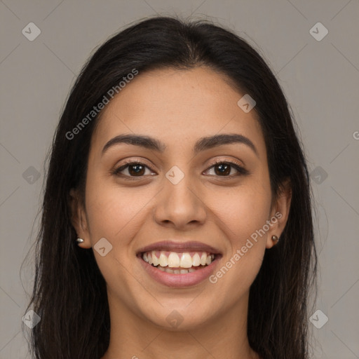 Joyful latino young-adult female with long  brown hair and brown eyes