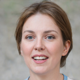 Joyful white young-adult female with medium  brown hair and blue eyes