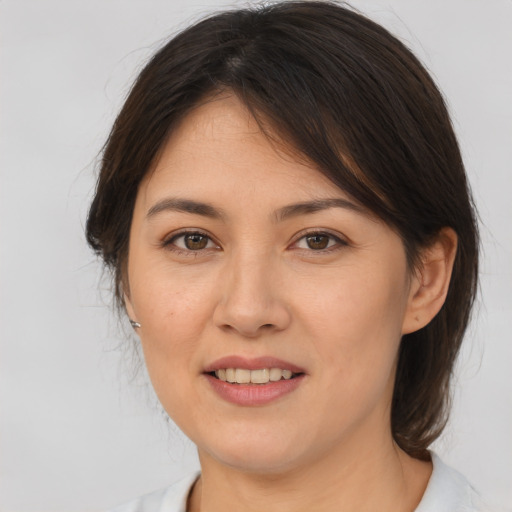 Joyful white young-adult female with medium  brown hair and brown eyes