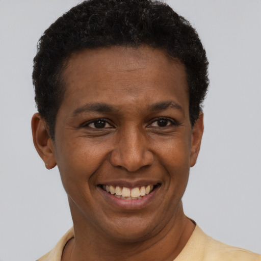 Joyful latino young-adult male with short  brown hair and brown eyes