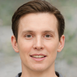 Joyful white young-adult male with short  brown hair and grey eyes