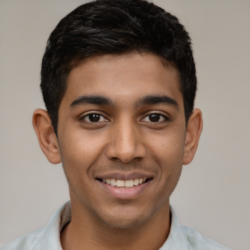 Joyful latino young-adult male with short  black hair and brown eyes
