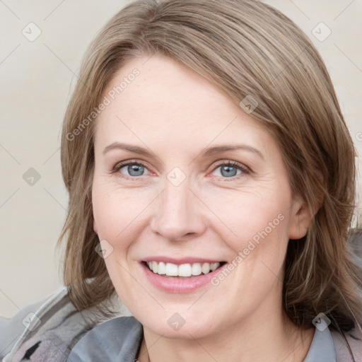 Joyful white young-adult female with medium  brown hair and blue eyes