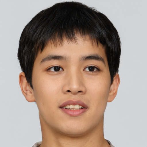 Joyful asian young-adult male with short  brown hair and brown eyes