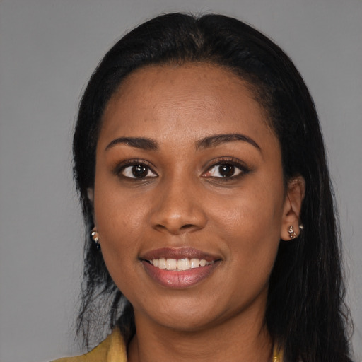Joyful black young-adult female with long  black hair and brown eyes