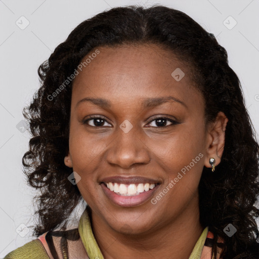 Joyful black young-adult female with long  brown hair and brown eyes