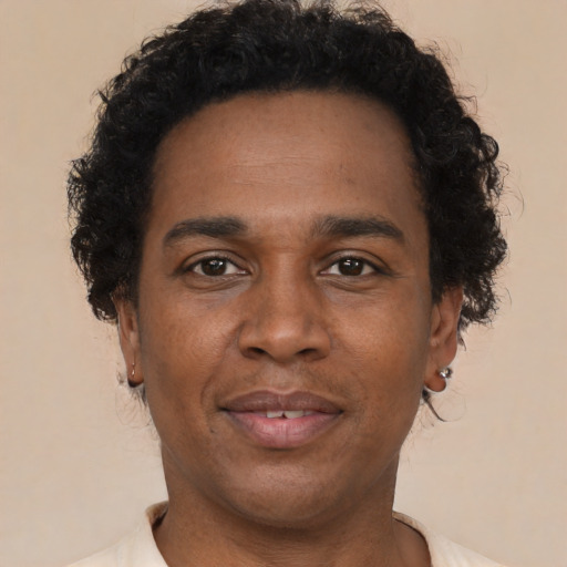 Joyful black adult male with short  brown hair and brown eyes